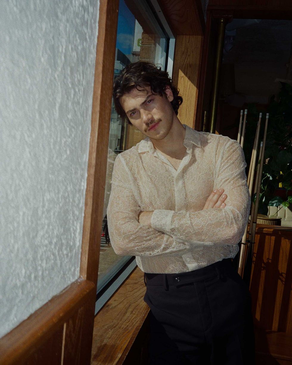 Jack Inannen standing near a window in a New York City Bar.