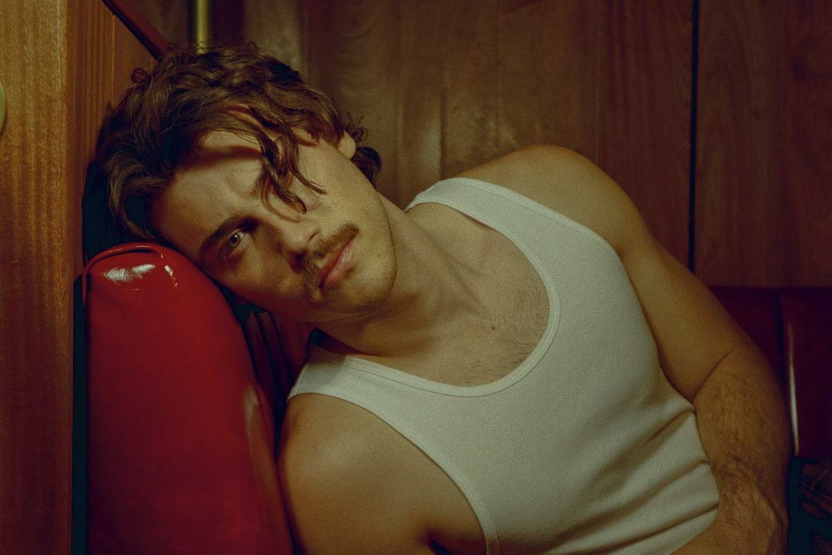 Jack Innanen in a white tank top and pants.