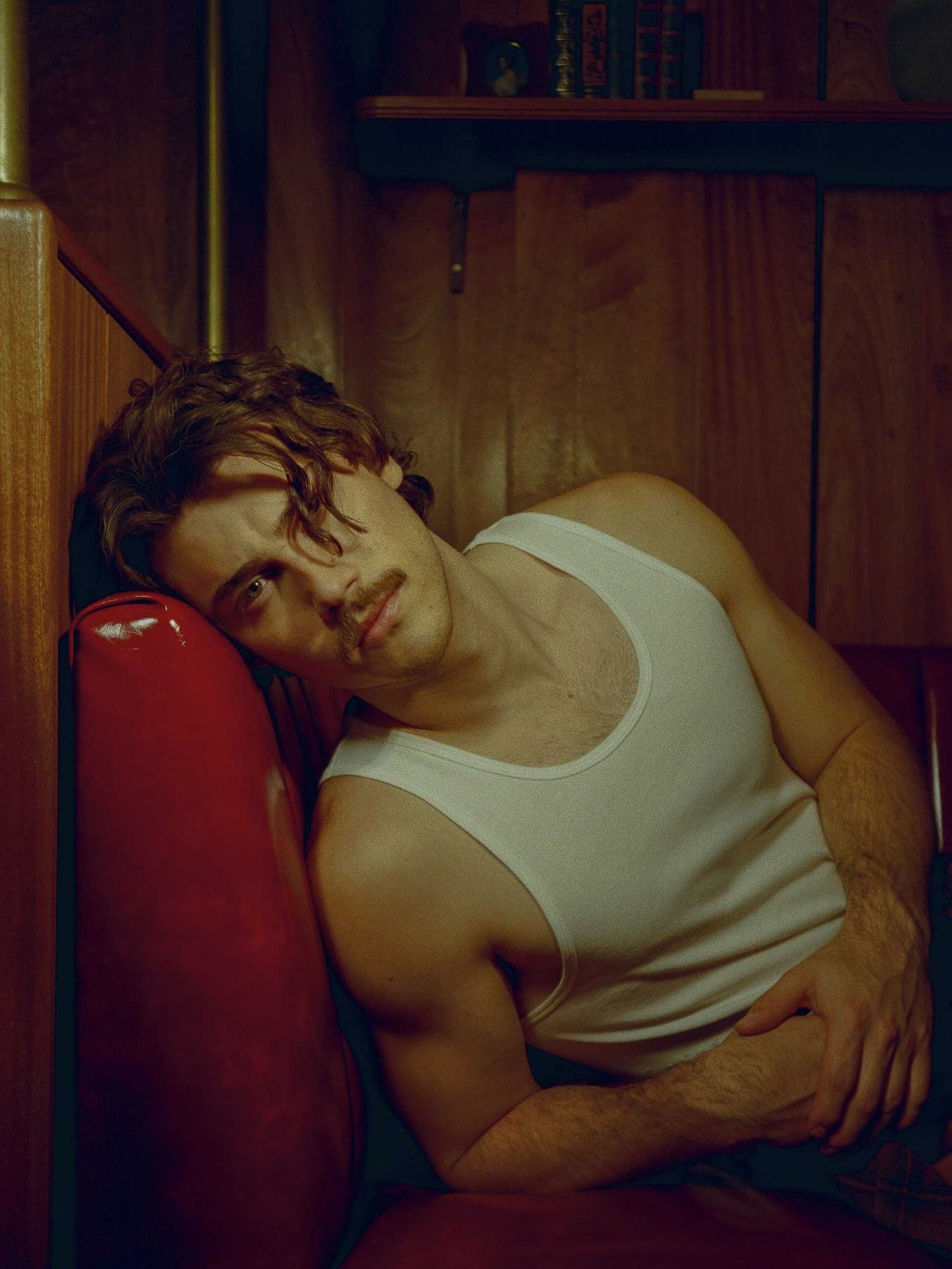 Jack Innanen in a white tank top and pants.