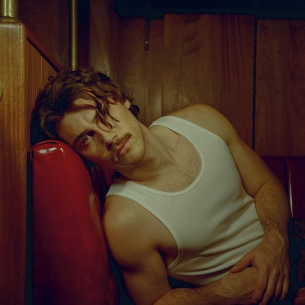 Jack Innanen in a white tank top and pants.