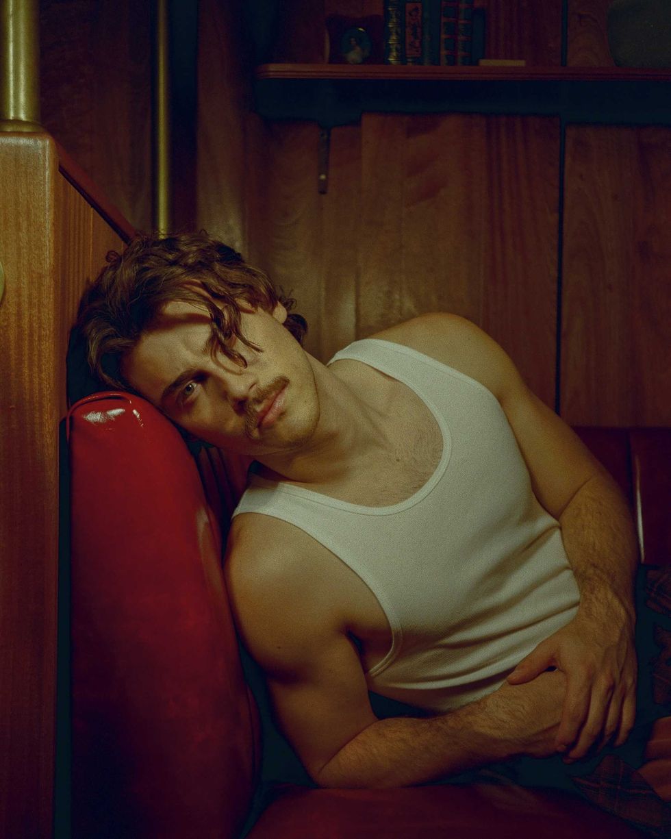 Jack Innanen in a white tank top and pants.