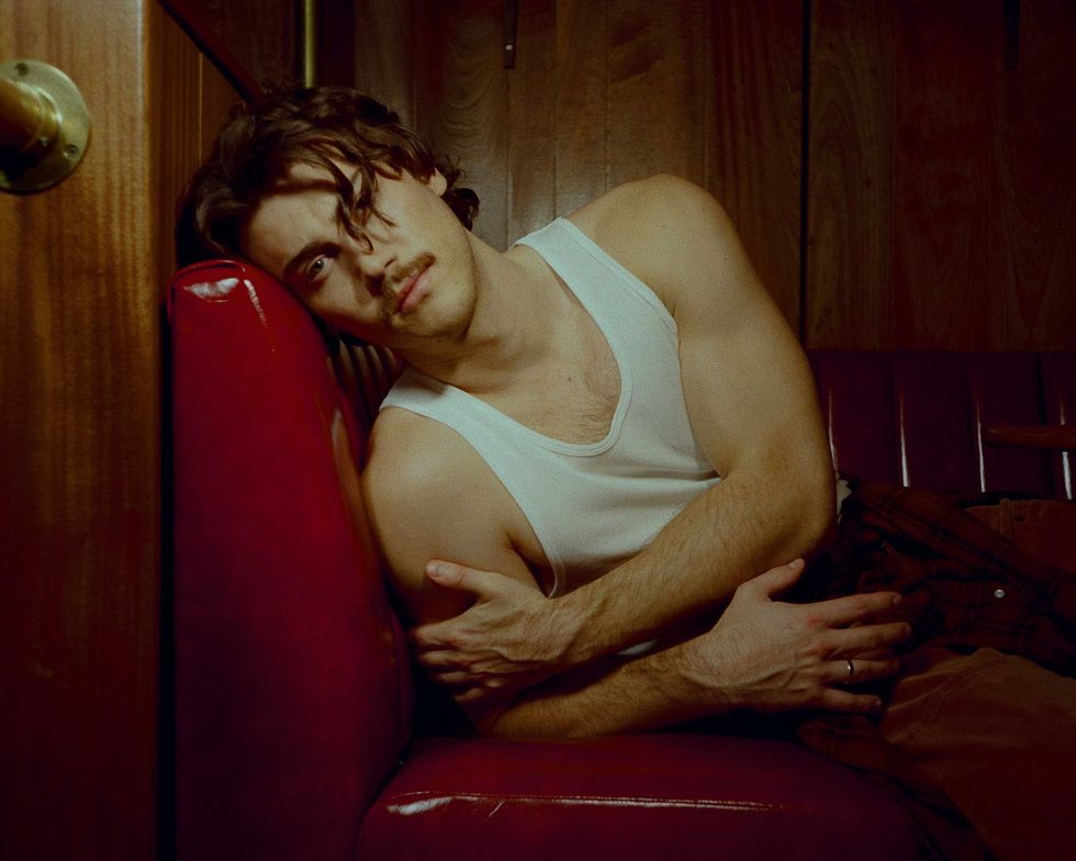 Jack Innanen in a white tank top and pants.