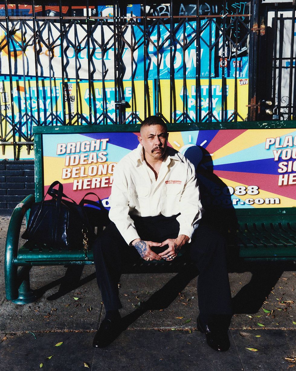 Willy Chavarr\u00eda Art Director Jess Cuevas sits at bus station bench